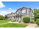 Inviting townhome exterior with manicured lawn, charming porch and attractive siding at 19216 E Idaho Pl # 102, Aurora, CO 80017