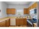 Bright kitchen features oak cabinets with laminate countertops and wood-look flooring, plus stainless appliances at 19216 E Idaho Pl # 102, Aurora, CO 80017