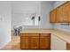 Spacious kitchen with light countertops and oak cabinets open to an eating area at 19216 E Idaho Pl # 102, Aurora, CO 80017