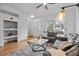 Open living room showcasing shelves, hardwood flooring, and plush sofas at 19216 E Idaho Pl # 102, Aurora, CO 80017