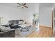 Comfortable living room with modern furniture, ceiling fan, and decorative wall paneling at 19216 E Idaho Pl # 102, Aurora, CO 80017