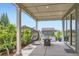A cozy, covered back porch is furnished with comfortable seating and ample space for entertaining at 4526 Colorado River Dr, Firestone, CO 80504