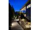 Beautiful landscaped backyard with landscape lighting and a view of the patio area at 4526 Colorado River Dr, Firestone, CO 80504