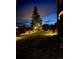 Well-maintained backyard featuring landscape lighting and an open grassy area at 4526 Colorado River Dr, Firestone, CO 80504