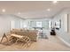 Spacious finished basement features a large sectional, play area, and lighting at 4526 Colorado River Dr, Firestone, CO 80504