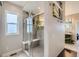 Clean bathroom has a glass shower with a bench seat and hanging plants at 4526 Colorado River Dr, Firestone, CO 80504