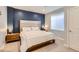Bedroom with a blue accent wall and a large window at 4526 Colorado River Dr, Firestone, CO 80504