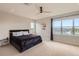 Bright bedroom with a fan, black bed frame, and view at 4526 Colorado River Dr, Firestone, CO 80504