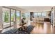 Bright dining room with modern table and view to kitchen, and outdoor patio at 4526 Colorado River Dr, Firestone, CO 80504