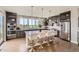 Modern kitchen featuring stainless steel appliances, a large island with seating, and ample natural light at 4526 Colorado River Dr, Firestone, CO 80504