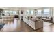 Open-concept living room with hardwood floors, and a large sectional sofa at 4526 Colorado River Dr, Firestone, CO 80504