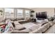 Comfortable living room featuring a large sectional sofa, hardwood floors, and a fireplace at 4526 Colorado River Dr, Firestone, CO 80504
