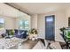 Sunlit living room featuring modern sliding glass door and an accent rug at 4526 Colorado River Dr, Firestone, CO 80504
