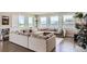 Spacious living room features a large sectional sofa, hardwood floors, and lots of natural light at 4526 Colorado River Dr, Firestone, CO 80504