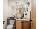 Clean bathroom with light wood cabinets and a large mirror at 7112 E 131St Pl, Thornton, CO 80602