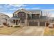 Two-story house with stone accents, a three-car garage, and a covered porch at 7112 E 131St Pl, Thornton, CO 80602