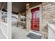 Inviting front porch with seating area and red front door at 7112 E 131St Pl, Thornton, CO 80602