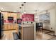 Kitchen with light wood cabinets, a large island, and black appliances at 7112 E 131St Pl, Thornton, CO 80602