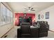 Living room with black leather furniture and a large TV at 7112 E 131St Pl, Thornton, CO 80602