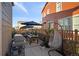Backyard patio with an outdoor kitchen, dining set, and hanging swing chair at 3061 Low Meadow Blvd, Castle Rock, CO 80109