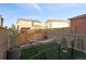 Well-maintained backyard with privacy fence, hammock, synthetic grass and mature trees at 3061 Low Meadow Blvd, Castle Rock, CO 80109