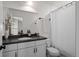 Bathroom with a white vanity, gray countertop, and framed mirror with white floral decoration at 3061 Low Meadow Blvd, Castle Rock, CO 80109