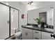 Bathroom with a glass door shower, gray countertops, white cabinetry, and double sinks at 3061 Low Meadow Blvd, Castle Rock, CO 80109