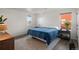 Bright bedroom with blue bedding, white walls, a large window and decor at 3061 Low Meadow Blvd, Castle Rock, CO 80109