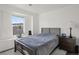 Bright bedroom with gray bedding, a decorative ledge and a dark wood frame bed at 3061 Low Meadow Blvd, Castle Rock, CO 80109