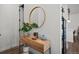 Stylish entryway featuring wood console table with round mirror and decor at 3061 Low Meadow Blvd, Castle Rock, CO 80109