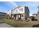 Charming two-story home with a covered porch, stone accents, and a well-maintained lawn at 3061 Low Meadow Blvd, Castle Rock, CO 80109