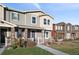 Charming two-story townhome with stone accents, covered porch, and well-manicured landscaping at 3061 Low Meadow Blvd, Castle Rock, CO 80109