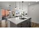 Open-concept kitchen with island, stone countertops, stainless steel appliances, and dining area at 3061 Low Meadow Blvd, Castle Rock, CO 80109
