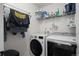 Functional laundry room with modern appliances, shelving, and ample storage at 3061 Low Meadow Blvd, Castle Rock, CO 80109