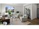 Bright and airy living room with comfortable seating, lots of plants, and an open layout at 3061 Low Meadow Blvd, Castle Rock, CO 80109