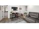 Living room featuring gray sofa, entertainment center, neutral rug, and modern flooring at 3061 Low Meadow Blvd, Castle Rock, CO 80109