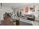 Sunlit living room with hardwood floors, stylish furnishings, and access to an outdoor patio at 3061 Low Meadow Blvd, Castle Rock, CO 80109