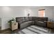 Comfortable living room with a large gray sectional sofa, neutral rug, and natural light at 3061 Low Meadow Blvd, Castle Rock, CO 80109