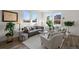 Cozy living room with a comfortable sofa, lots of plants, and natural light from the windows at 3061 Low Meadow Blvd, Castle Rock, CO 80109