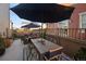 Outdoor patio with a dining set, lounge area, and shade umbrellas for entertaining at 3061 Low Meadow Blvd, Castle Rock, CO 80109