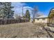 Large backyard with a fire pit and shed, offering ample outdoor space and storage at 10705 Downing St, Northglenn, CO 80233