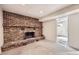 Close-up of the brick fireplace with decorative mantle in the unfinished basement at 10705 Downing St, Northglenn, CO 80233