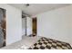 View of the basement room with checkered flooring and access to another room at 10705 Downing St, Northglenn, CO 80233