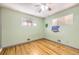 Minimalist bedroom with hardwood floors and natural light, showcasing a blank canvas for personalization at 10705 Downing St, Northglenn, CO 80233