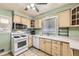 Bright and functional kitchen with modern appliances, light-colored cabinetry, and ample countertop space at 10705 Downing St, Northglenn, CO 80233