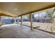 Relaxing covered patio, offering a backyard view with stone walkway and wood fence at 10705 Downing St, Northglenn, CO 80233