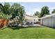 Backyard featuring both a grass lawn and gravel area with shade sail, outdoor kitchen, and patio seating at 3055 S Bannock St, Englewood, CO 80110