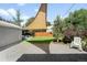 Backyard featuring a large lawn area, shade sail, seating area with fire pit, and low-maintenance landscaping at 3055 S Bannock St, Englewood, CO 80110