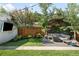 Landscaped backyard with a seating area, trees, and privacy fence at 3055 S Bannock St, Englewood, CO 80110
