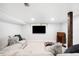 Cozy finished basement with a comfortable couch and mounted TV at 3055 S Bannock St, Englewood, CO 80110